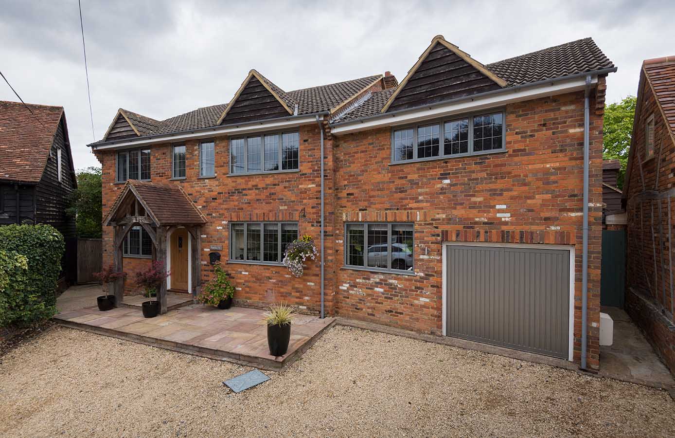 House with grey aluminium flush sash windows